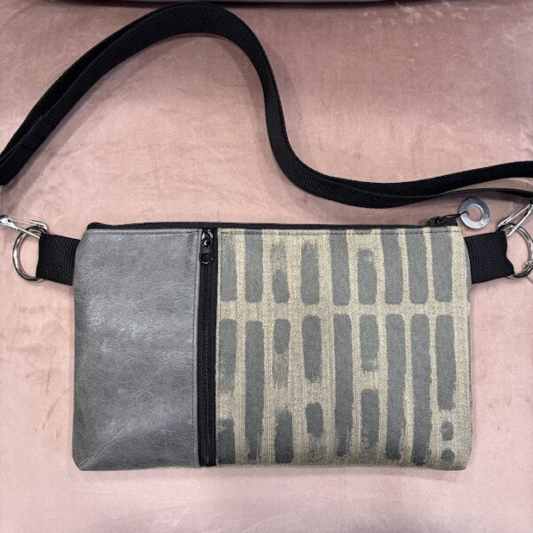 Custom bag-straw colored fabric with grey stripe design-black vertical zipper and grey leather strip. pink background